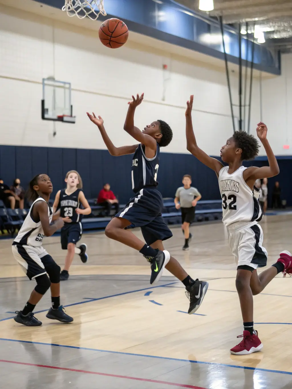 A group of young athletes playing basketball, emphasizing agility and coordination.